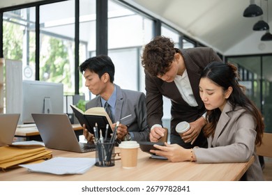 Group of young professionals collaborating on a project using digital devices in a modern office. - Powered by Shutterstock - Get 15% off with code: PIKWIZARD15