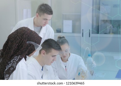 Group of young  scientists doing experiments in laboratory