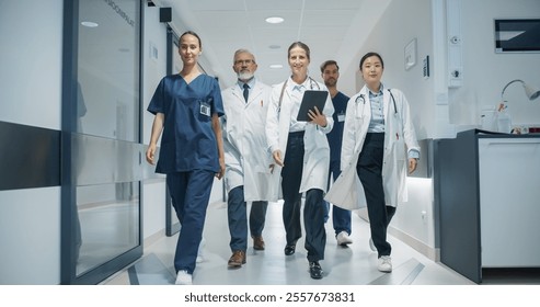 Group of Young and Senior Male and Female Physicians, Doctors, Surgeons, Nurses, General Practitioners, Posing in a Hospital Hallway, Walking Together, Ready to Save Lives - Powered by Shutterstock