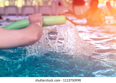 Group Or Young And Senior People In Aquarobic Fitness Swimming Pool Exercising