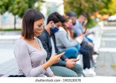 Group Of Young Social Network Addicts Looking For News On Covid19, Stress From False Information And Negative News, Social Isolation And Stress, Focus On Brunette Girl Looking At Smartphone