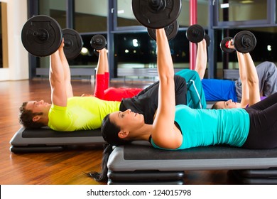 Group Of Young Sport People Training With Barbell At A Gym For Better Fitness