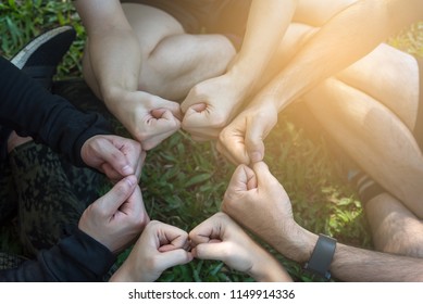 Group Of Young Sport Team Hands Together, Team Partners Giving Fist Bump Come Together For Sport Battle Outdoor. Corporate Teamwork Partnership. Meeting,business Concept,vintage Tone