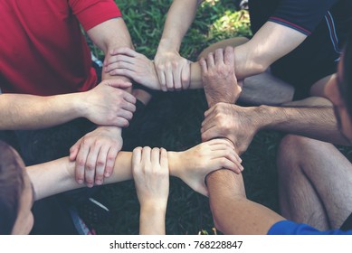 Group Of Young Sport Team Hands Together, Team Partners Giving Fist Bump Come Together For Sport Battle Outdoor. Corporate Teamwork Partnership. Meeting,business Concept,vintage Tone