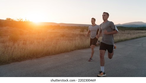 Group Of Young Sporty People Jogging On A Sunny Morning In The City.