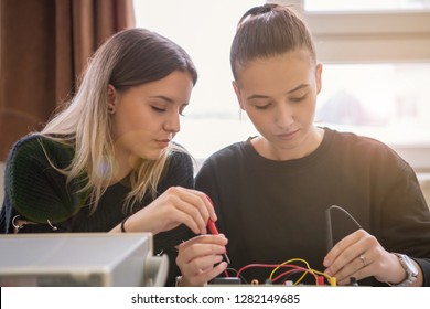 Group of young students doing technical vocational practice with teacher in the electronic classroom, Education and technology concept