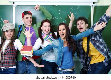 Group Of Young Students Having Fun On The Background Of The School Board