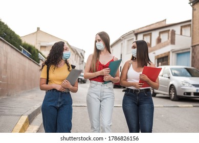  Group Of Young Students In Protective Masks Walking Down The Street