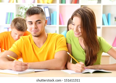 Group of young students sitting at the library