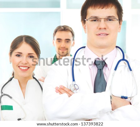 Group of young and successful doctors over the abstract background