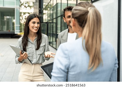 Group of young successful professional business people standing outside office building discussing opportunities and prepare for corporate staff meeting of employees. Occupational and employee concept - Powered by Shutterstock