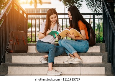 A Group Of Young Or Teen Asian Student In University Smiling And Reading The Book And Look At The Tablet Or Laptop Computer In Summer Holiday.