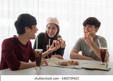 Group of young teens Asian friend are happy and funny eating pizza and soft drink together. Lifestyle of teenagers and friendship. - Powered by Shutterstock