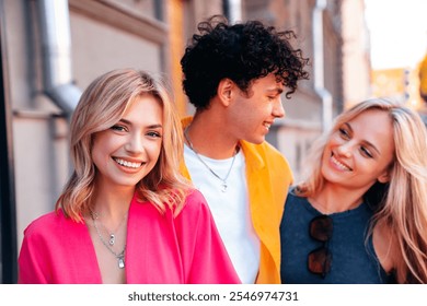 Group of young three stylish friends posing in the street. Fashion man and two cute female dressed in casual summer clothes. Smiling models having fun. Cheerful women and guy outdoors - Powered by Shutterstock