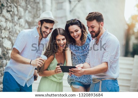 Similar – Young happy people looking tablet over table