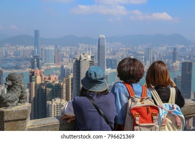 Group Of Young Tourists Were Looking To The Great And Beautiful View Of High Business Building At Victoria Peak, Hong Kong