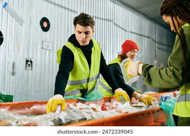 A group of young volunteers in gloves and safety vests sort items in a warehouse, working together to make a positive impact. - Powered by Shutterstock