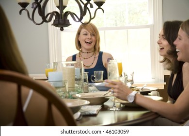 A Group Of Young Women Eating Lunch In A Well-lit Dining Room