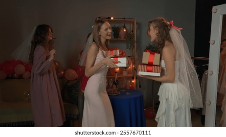 Group of young women friends and bride celebrating bachelorette party at home, bridesmaids gifting presents to bride, congratulating and smiling.. - Powered by Shutterstock