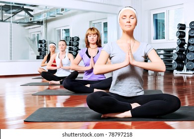 Group Of Young Women In The Gym Centre. Yoga.