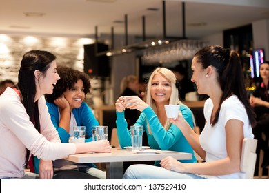 group of young women on coffee break, enjoying in discussion - Powered by Shutterstock