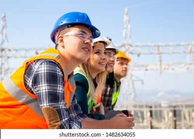 Group Of Young Workers Looking Ahead In Electric Power Station