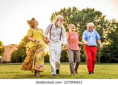 Group Of Youthful Seniors Having Fun Outdoors - Four Pensioners Bonding Outdoors, Concepts About Lifestyle And Elderly