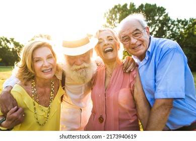 Group Of Youthful Seniors Having Fun Outdoors - Four Pensioners Bonding Outdoors, Concepts About Lifestyle And Elderly