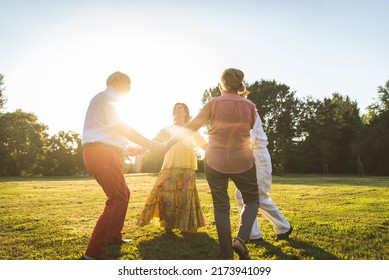 Group Of Youthful Seniors Having Fun Outdoors - Four Pensioners Bonding Outdoors, Concepts About Lifestyle And Elderly