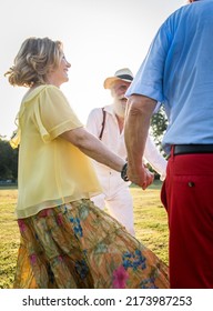 Group Of Youthful Seniors Having Fun Outdoors - Four Pensioners Bonding Outdoors, Concepts About Lifestyle And Elderly