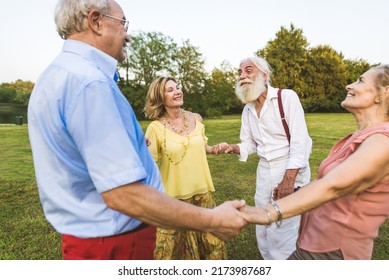 Group Of Youthful Seniors Having Fun Outdoors - Four Pensioners Bonding Outdoors, Concepts About Lifestyle And Elderly