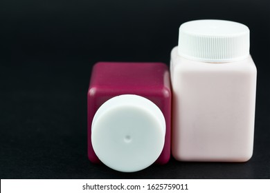 Groupe of cosmetic bottles at black background