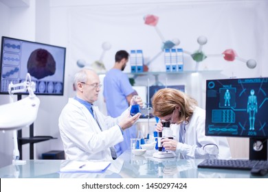 Groupe of researchers in pharmacology in a hospital laboratory. Modern equipment in research laboratory. - Shutterstock ID 1450297424