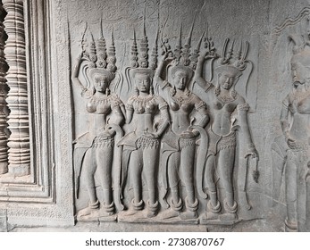 A grouping of Devatas occupying the wall space of a corner of a tower, Angkor Wat, Angkor Archaeological Park, Siem Reap Province, Cambodia. 