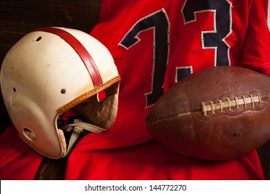 A Grouping Of Vintage, Antique American Football Items Including An Helmet, Jersey, And Old Leather Football