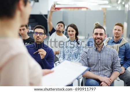 Groupmates listening to lecturer or speaker at conference