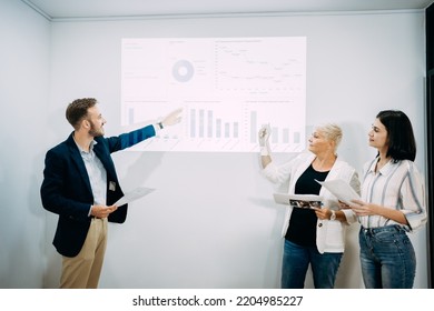 Groups Of Business People Diverse Meeting Presentation Charts And Business Reports Together On The Board In The Office, Planning Strategy New Marketing Projects, And Teamwork Concepts.