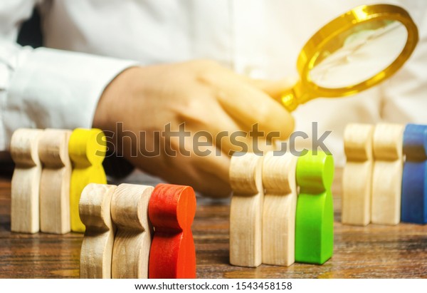 Groups of multicolored wooden people and\
businessman. The concept of market segmentation. Target audience,\
customer care. Market group of buyers. Customer relationship\
management. Selective\
focus