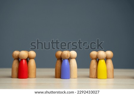 Groups of multicolored wooden people on a gray background. The concept of market segmentation. Target audience, customer care. Market group of buyers. Customer relationship management. Selective focus