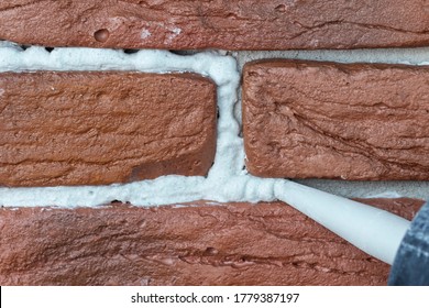 Grouting Decorative Gypsum Brick With White Cement Grout. Closeup.