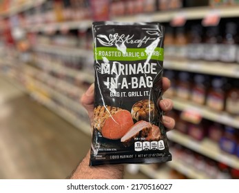 Grovetown, GA USA - 06 10 22: Retail Store Hand Holding Marinade In A Bag