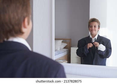 Growing up like dad. Shot of a young boy wearing his fathers suit and pretending to be a businessman.