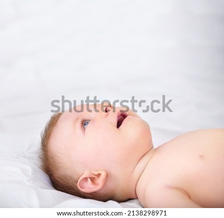 Similar – Newborn baby girl sleeping on blue sheets at home