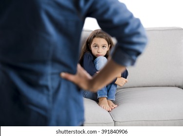 Grown up rebuking a little child for bad behavior
