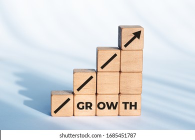 Growth Or Business Concept. Arrow Icon And Word On Wooden Dices