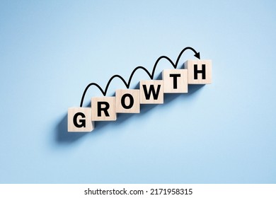 Growth business performance progress and increasing success concept wooden blocks and arrow moving up ladder - Shutterstock ID 2171958315