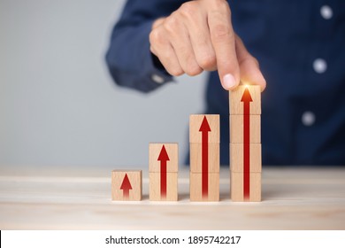 Growth graph and arrows ladder career path for business growth success process concept.Hand arranging wood block stacking as step stair with arrow up.