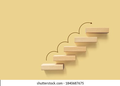 Growth or increase design concept. Cube block staircase moving step growing up to target. Success achievement or goal business motivation