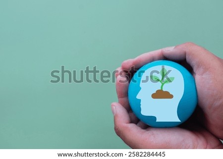 Growth Mindset and Personal Development Concept, Hands Holding blue balloon with growth mindset icon idea for Learning, Success, and Motivation.