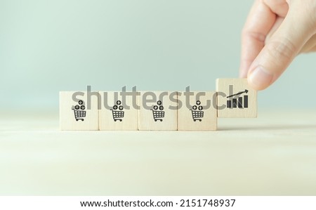 Growth of sales, average order value (AOV) concept. Strategy to get more money per oder. Increase sales in online store, e-commerce.  Completed wooden cubes with sales growth on grey background.